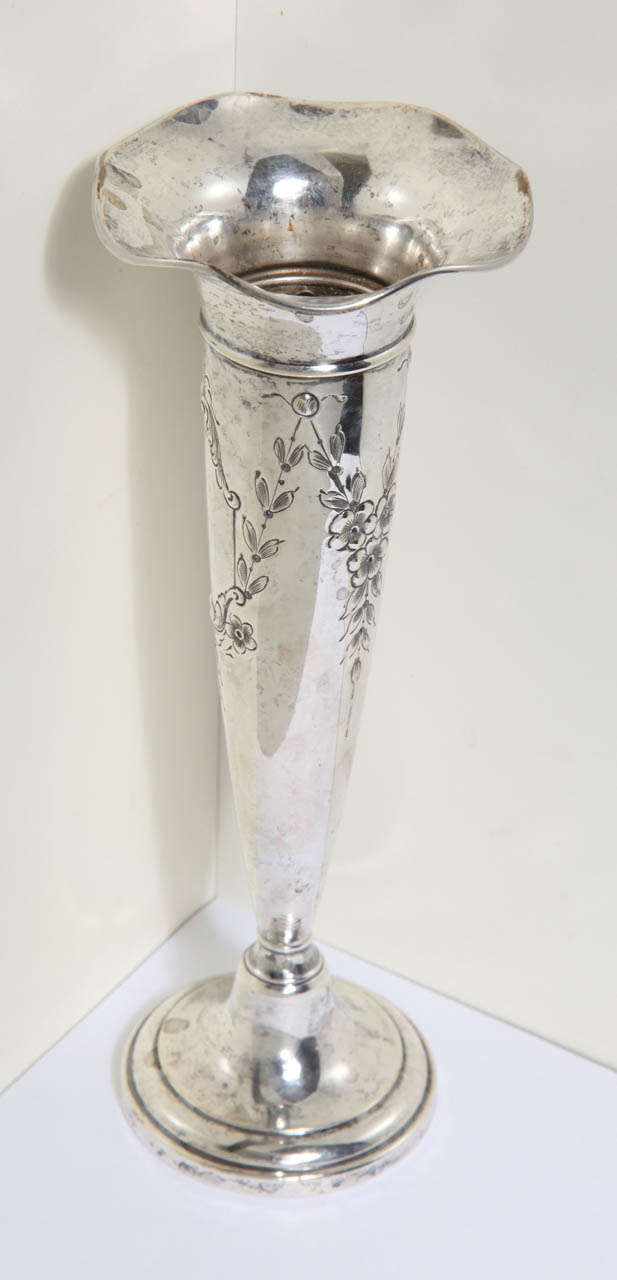 Gorgeous Sterling Silver Trumpet Vase. This antique vase is decorated with flower garland. The Hallmark is at the bottom. The antique vase is weighted.