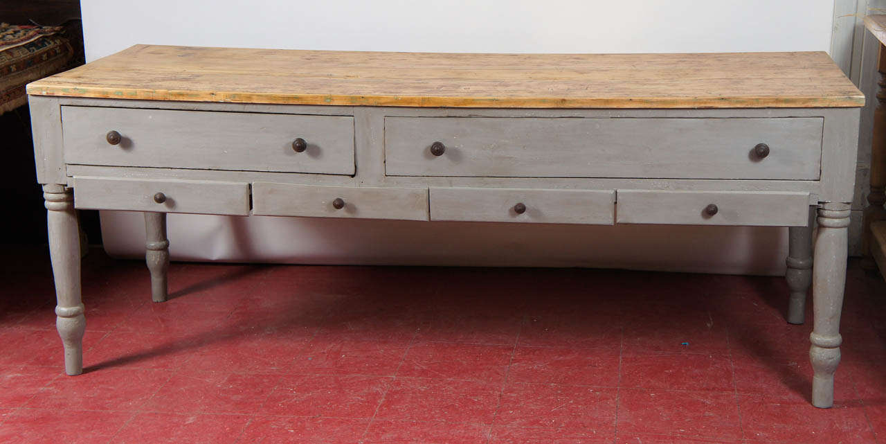 This country worktable kitchen counter can be used as a kitchen island or a counter.  Top has been stripped, leaving a great patina.  Table has turned legs, 2 large and 4 small drawers for storage.  Finished in a French grey.  Can work perfectly in