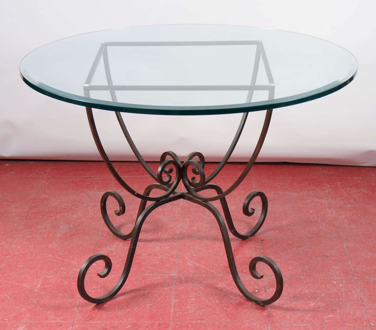 Round or square indoor or patio table.  Metal base with curled legs, gently curved support for glass top.  Table base measures 24 x 24 x 29