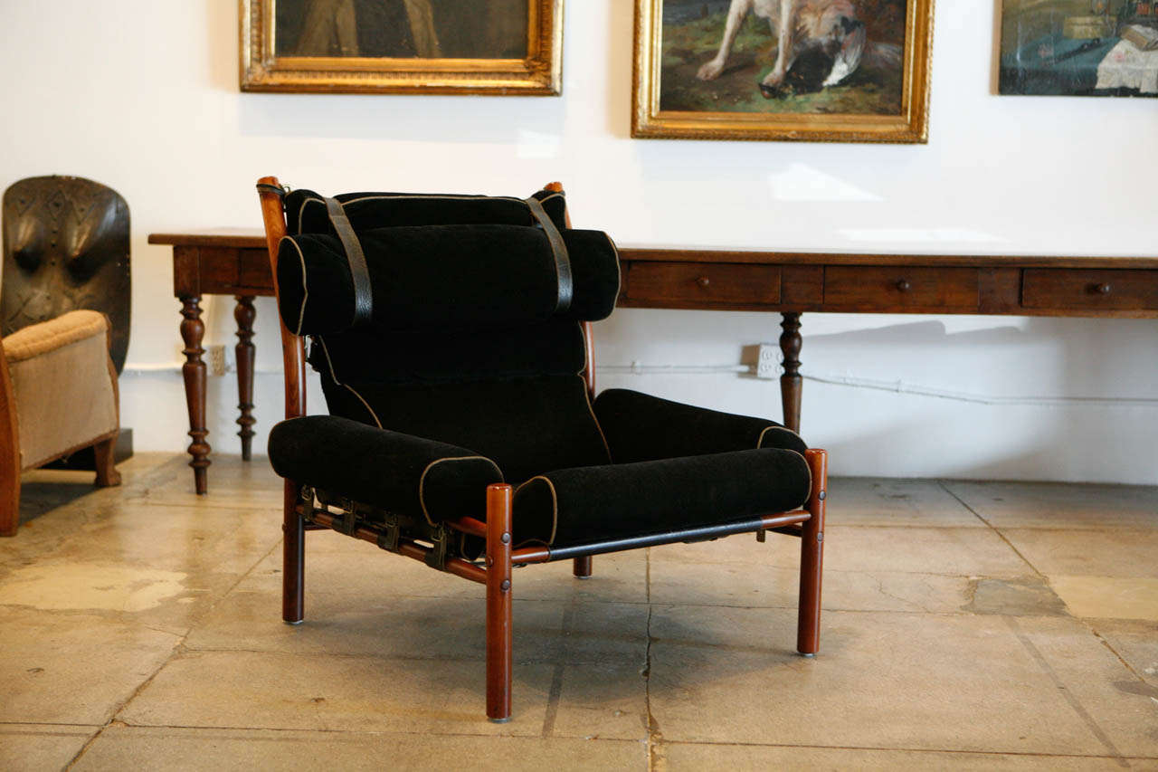 arne norell's inka chair upholstered in his dark house fabric with contrasting rust trim.