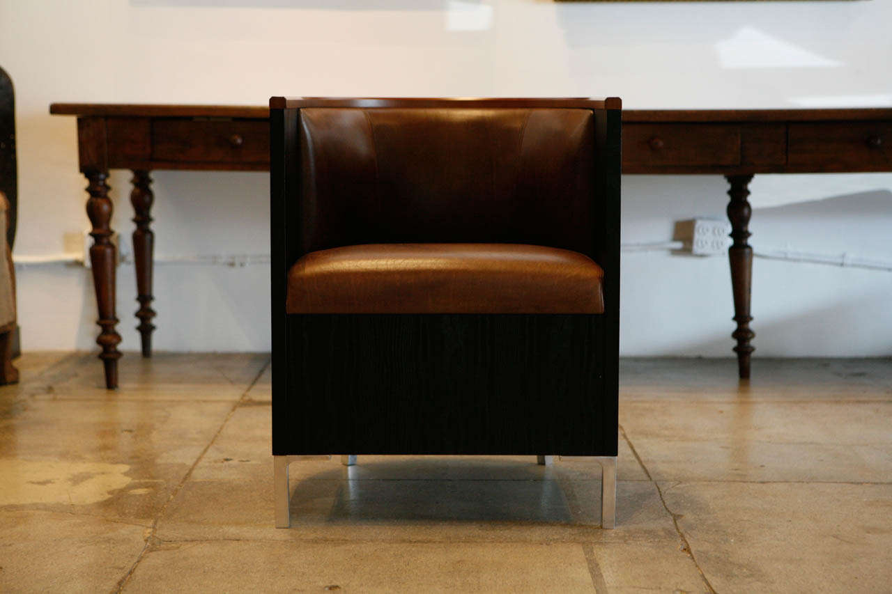 Mats Theselius' tra chair produced in many finishes & variations of leather and wood.
