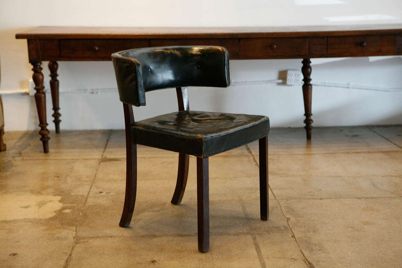 A beautifully handsome Swedish cabinetmaker's chair from the 1930s.
The leather is sort of indigo in color with the proportions perfectly askew.