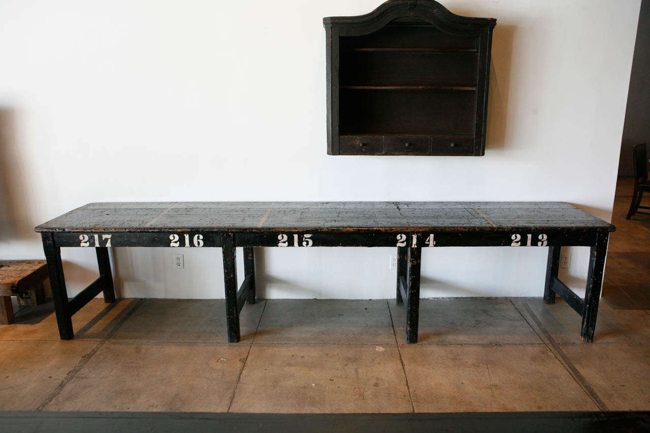 a large ebonized english market table with it's original product lines & numbers intact.
