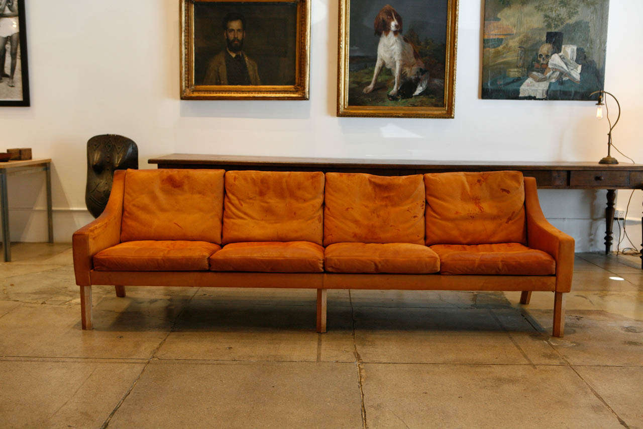 A 4-seater cognac sofa from Danish designer Poul Volther. Original leather and signature octagonal legs.
