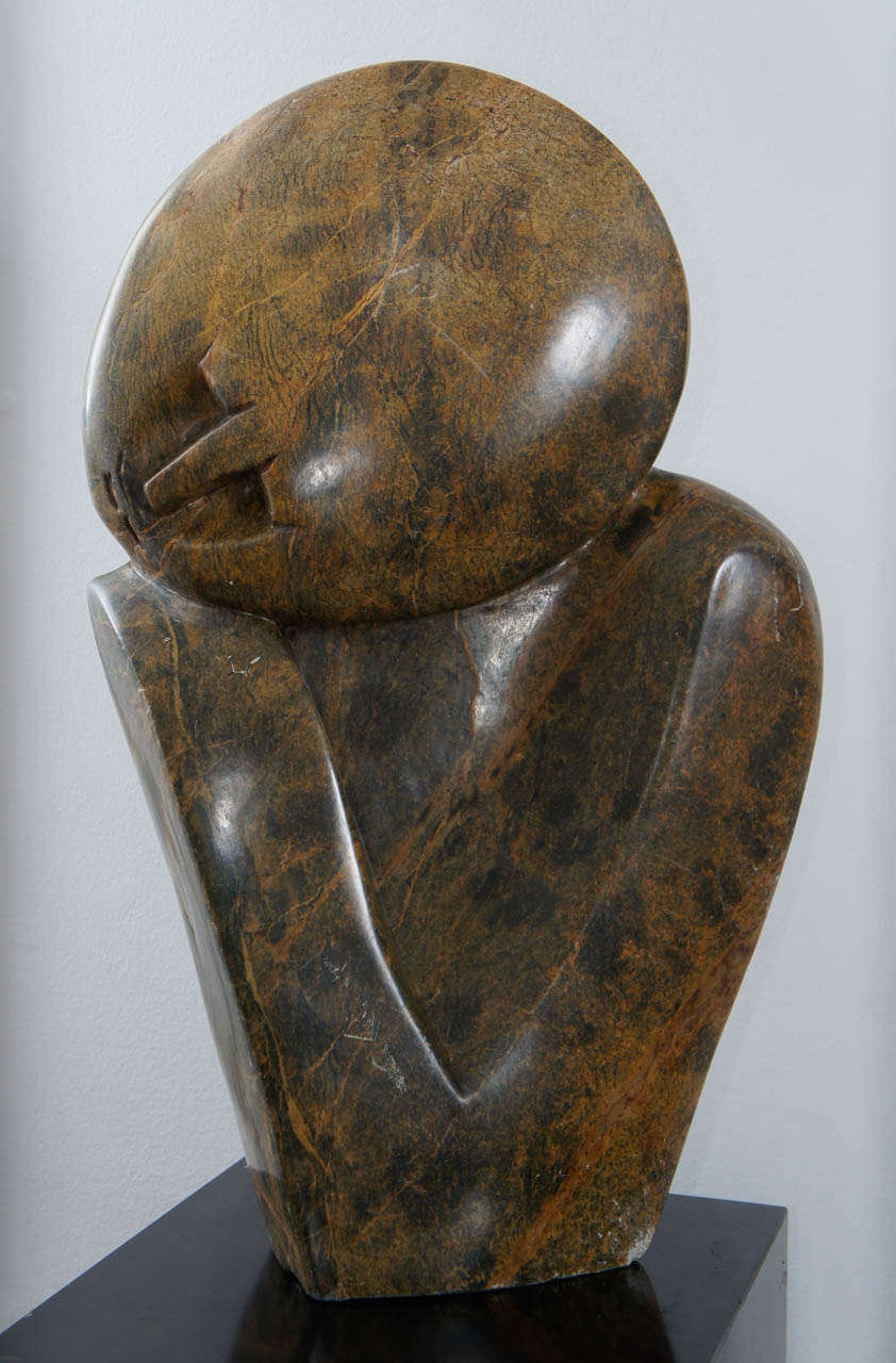 The area of Zimbabwe where this sculpture was made is well known for their Shona stonework. This piece, done by Michael Chiwandire, depicts a thoughtful subject, but makes a powerful impression. The piece is signed and special.