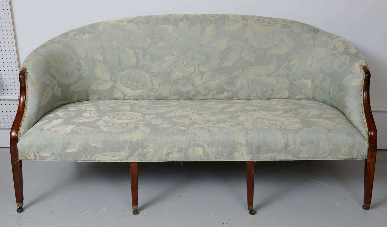 This sofa has been totally refurbished.  Newly upholstered & restored original finish.  Delicate design that makes it very versatile seating either against a wall or free floating in a room.  Tapered legs terminate with original brass