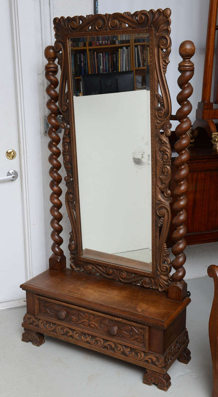Unusual cheval mirror with barley twist supports mounted on a base cabinet with a single drawer all hand carved, original restored finish

Originally $ 2,800.00