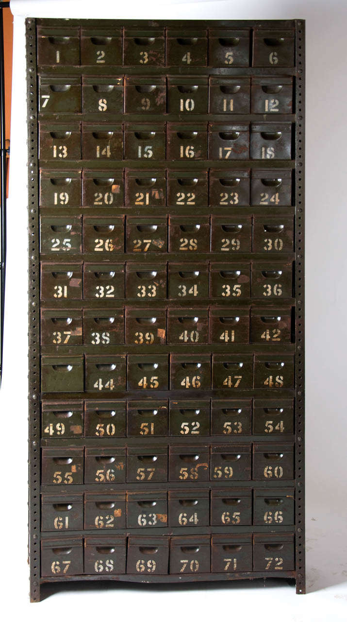 A British metal 72 drawer military cabinet from the Second World War used on R.A.F bases to store spare parts for repairing aircraft such as Spitfires and Lancaster bombers.