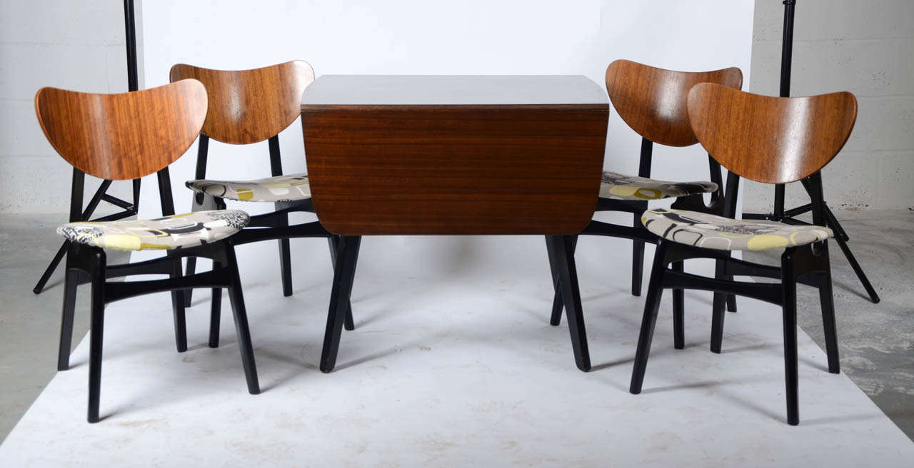 A 1960's G-Plan dining table and four matching chairs, newly upholstered in a fabric design from the world renowned Sanderson & Co, to give a near original look. Dimensions: Table 75 cm(H) x 76 cm(D) x 83 cm(W). The draw leaves extend the table to