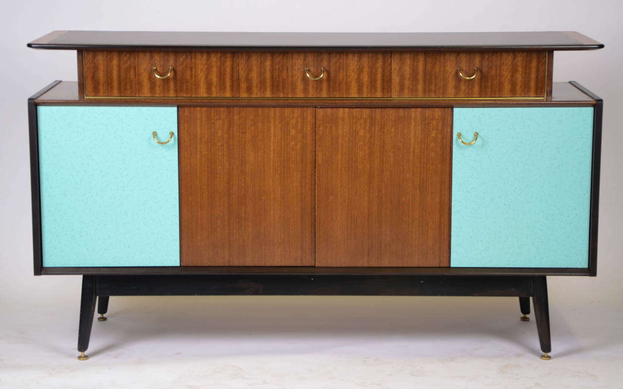 A British 1960's G-Plan teak and ebonised sideboard with colour laminate facings to wing doors and top.