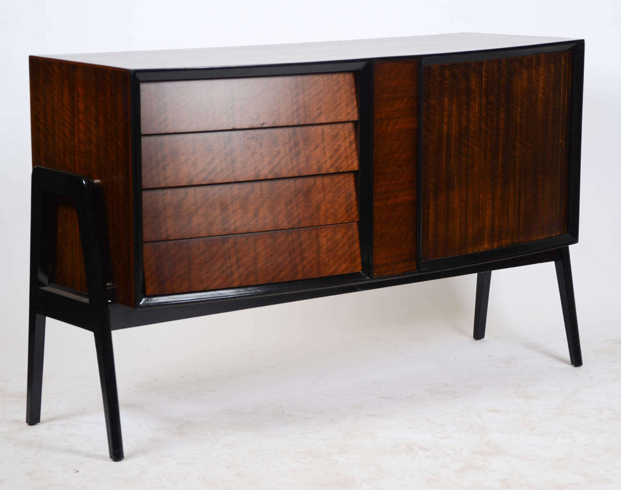 A British 1960's G-Plan (E. Gomme) teak and ebonized sideboard with an unusual rolling door mechanism.