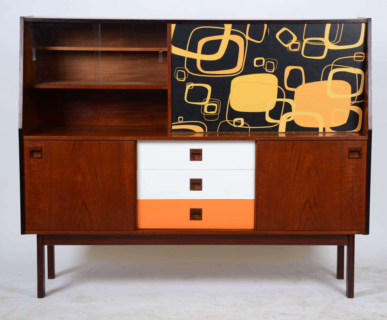 Portwood Furniture 1970's teak sideboard featuring unique graphics and color laminate drawer facings. Glass and timber sliding doors.