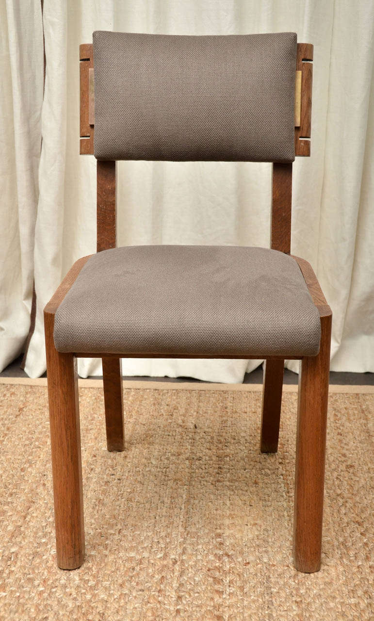 Set of Six Oak Framed Dining Chairs By Dudouyt. Fully Restored and Newly Upholstered in a Light Brown/Taupe Linen. Chairs have a small bronze bar detail on each side of the back rest.