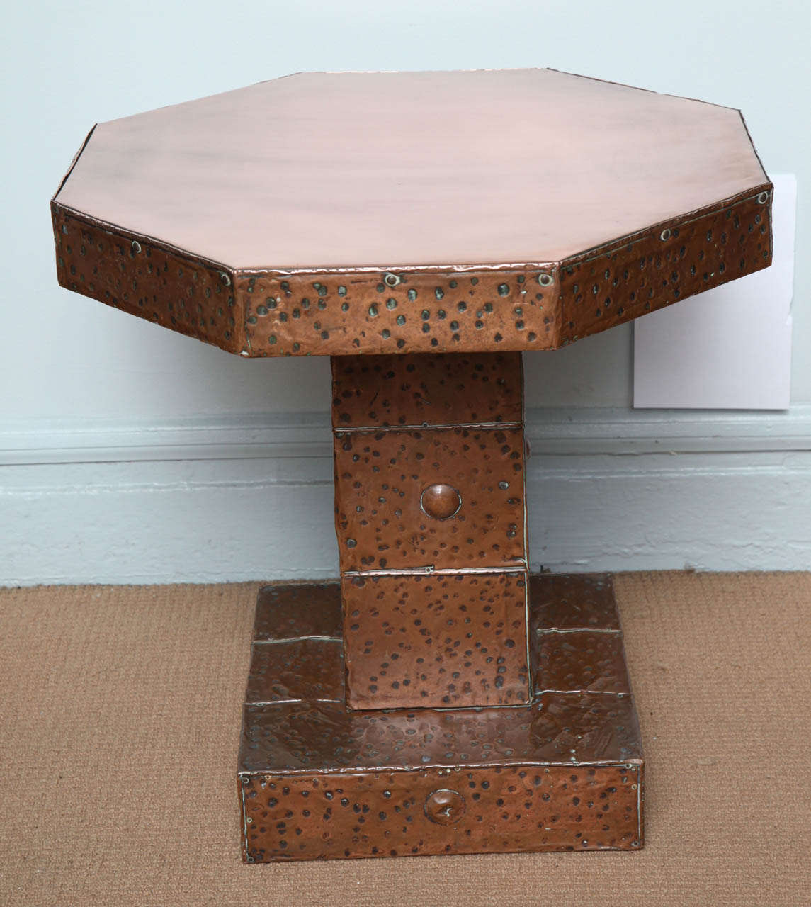 Unusual English Arts and Crafts hand hammered copper octagonal side table, the polished top with applied hammered edge, over square hammered shaft with round bosses, on hammered square platform base, the whole with pleasing patina.  Mirrors and