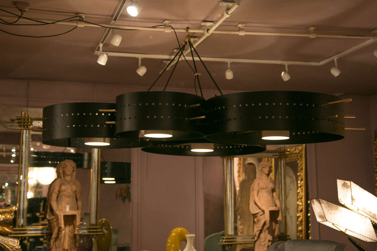 Spectacular black perforated metal suspension, brass gilt rods, regulation of the height by a system of flexible links, four light sources. Unique piece realized by an Italian architect. Newly electrified.