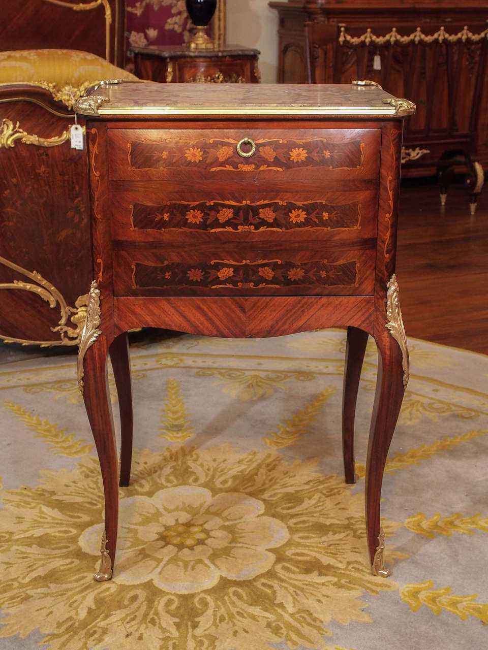 This liqueur chest opens up and has a mirrored interior. Unusual inlay. Lovely marquetry. Marble top.