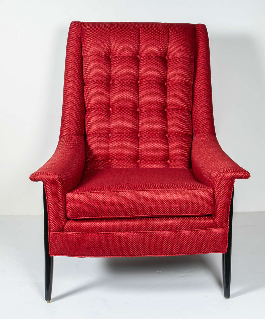 Biscuit tufted back newly reupholstered in Vermillion red woven tweed and refinished wooden ebonized frame and legs. The beautiful streamline Silhouette is an excellent example of the American Mid-Century Modern aesthetic.
