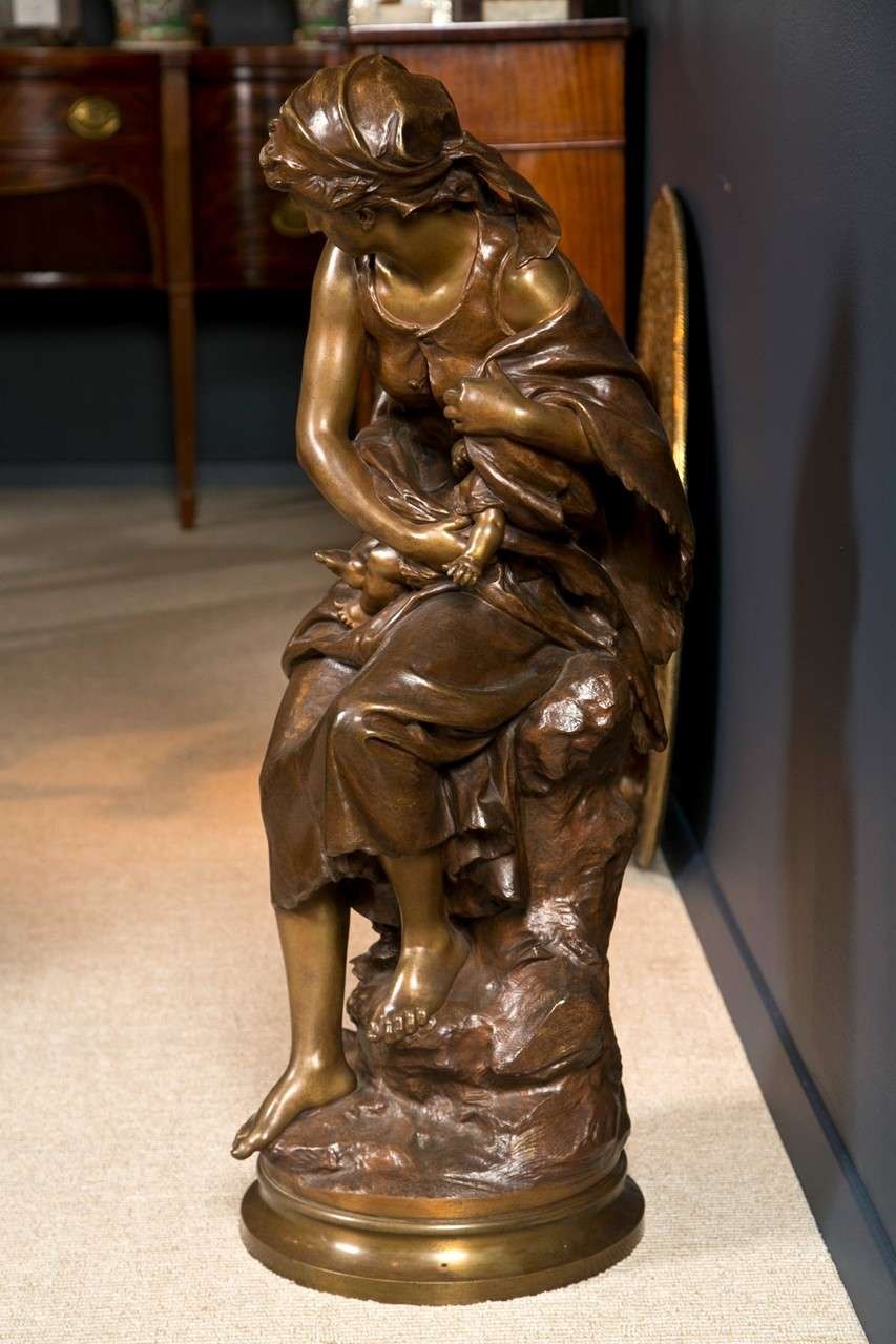 A French bronze statue of a mother and child by Mathurin Moreau of exceptional quality on a revolving gilded column socle.