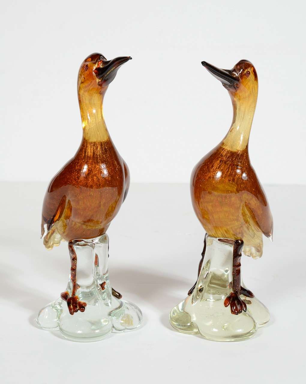 This pair of Mid-Century Modernist handblown Murano sculptures represent two birds, apparently cormorants, in stunning handblown glass replete with gold dust and affixed to a clear base. These would be perfect for a beach house, actually any house,