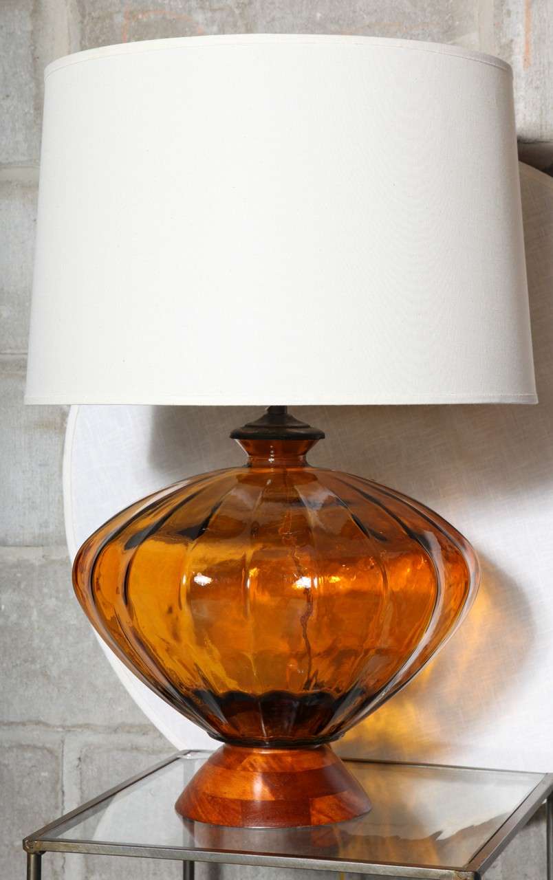 Deep, rich amber glass in an unusual shape on maple bases.RELOCATION SALE.  REDUCED 1800 to 950.00  Base is 14"  at the widest and 13 1/2 inches tall.   Linen shades shown but not included are 16 x 18 11 1/2 , 3-way 150 watts, LED ready. 