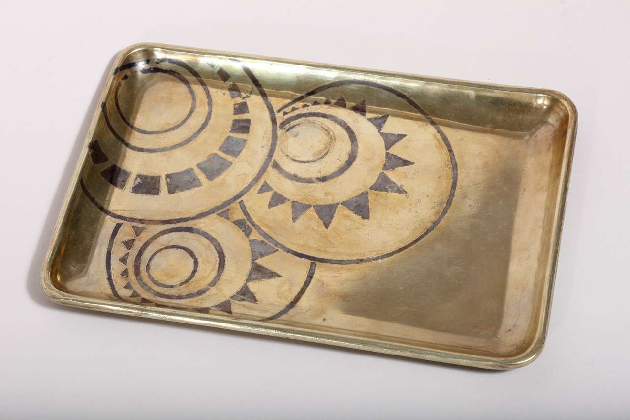 Dinanderie brass tray with a rolled rim inlaid with silver geometric design.
Signed: 