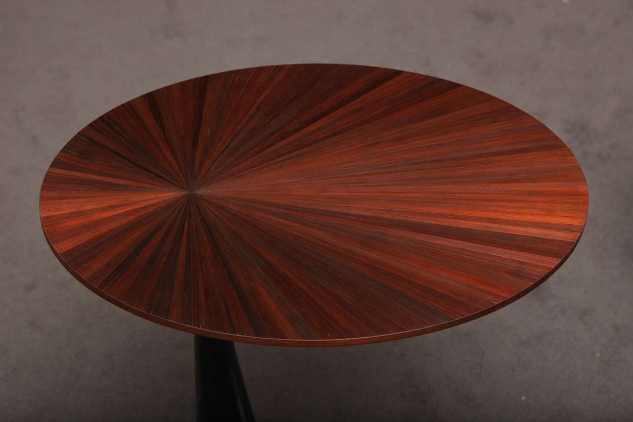 A side table by Hervé van der Straeten with a straw marquetry top and black patinated-bronze base.