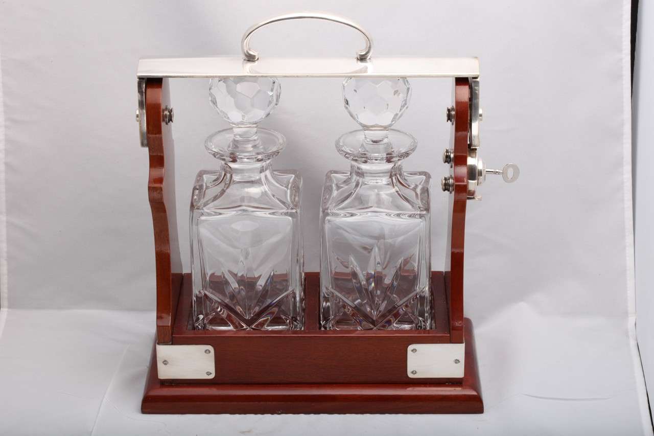Silverplate-mounted, two bottle, wood Tantalus, England, ca. 1930's-1940's. Locking mechanism in working order; has original key. @13 1/3