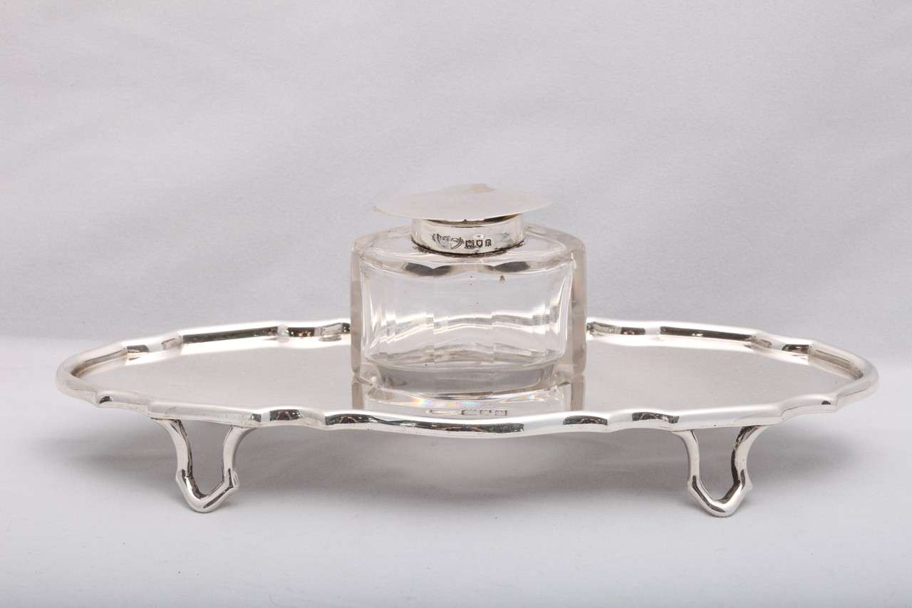 Edwardian, sterling silver, footed inkstand with original sterling silver-mounted, panel-cut crystal inkwell, London, 1912, Hawksworth, Eyre & Co. - makers. Unusual design. Measures: @7 3/4 inches wide x @3 1/8 inches deep (at deepest point) x @1