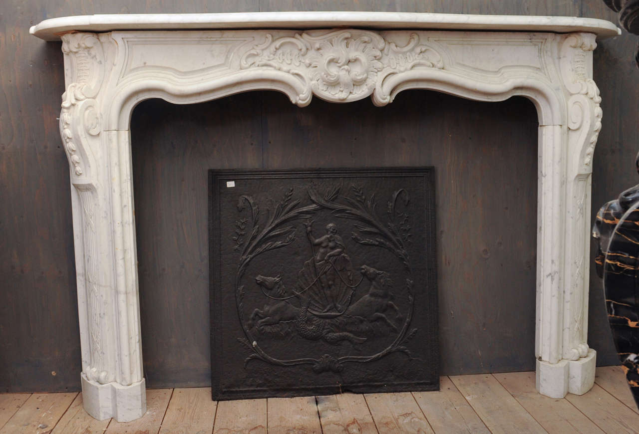 An important mid 18th Century French Rococo Carrara marble fireplace / mantel piece from an Amsterdam canal house, ca. 1750.