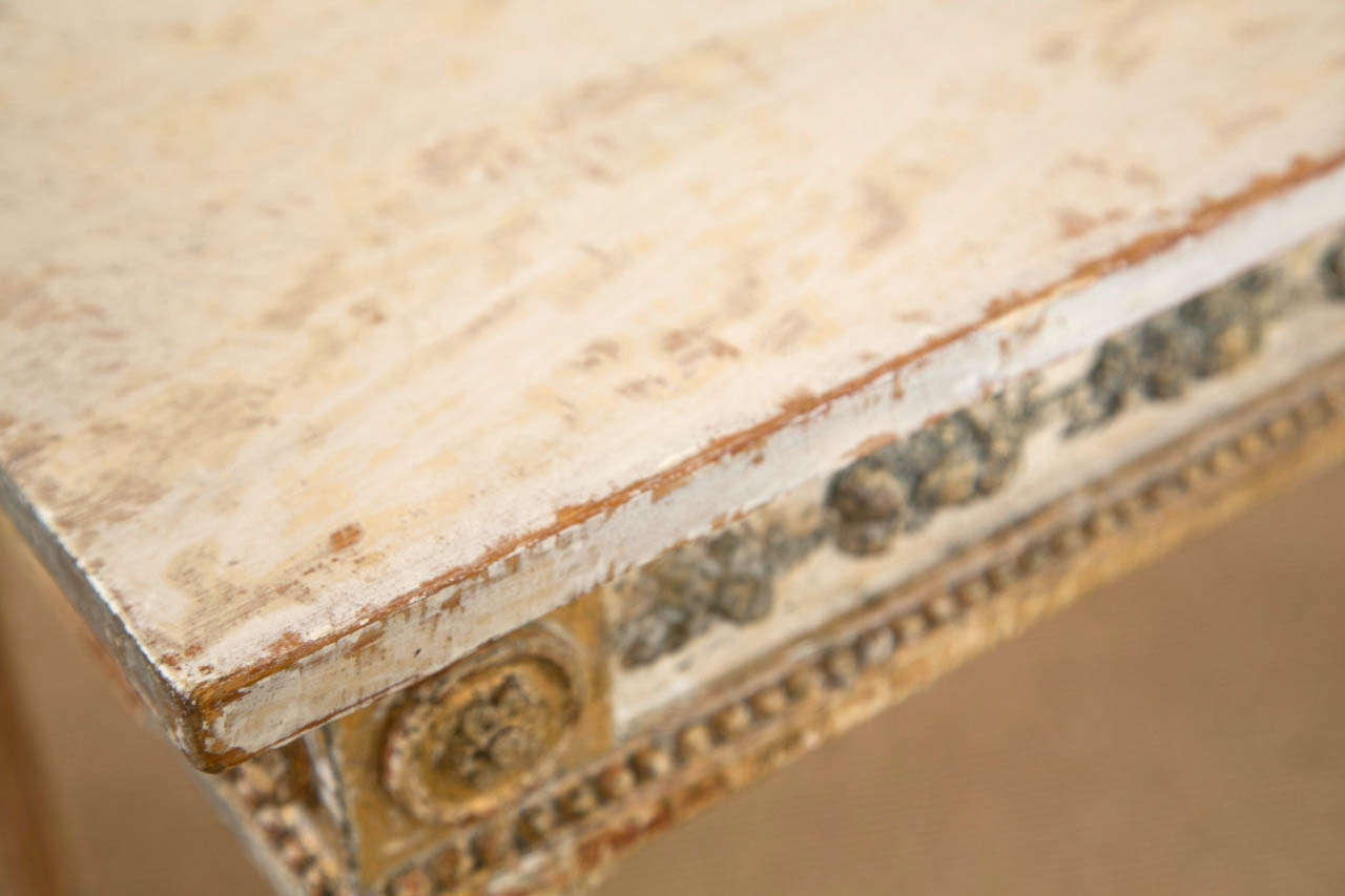 Regency Painted Wood Console Table, base is late 18th century, top is 19th century, carved with a intricate acanthus leaf border all around, on straight columnar legs, with a faux marble painted white top.