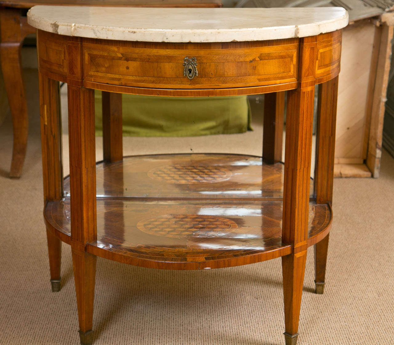 Continental Marquetry and Inlaid Demilune Marble Topped Entry Table, French or Italian, early 19 century, in the Directoire style, the lower tier with a marquetry design, with an added mirror on the back, all above one drawer, and a shaped white