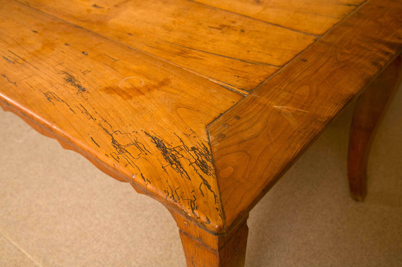 Louis XV Cherry Wood Refectory Table, third quarter 18th century, the original patina to the wood adds dimension to this table and the scrolling, undulating design and one drawer makes the table very stylish and useful.