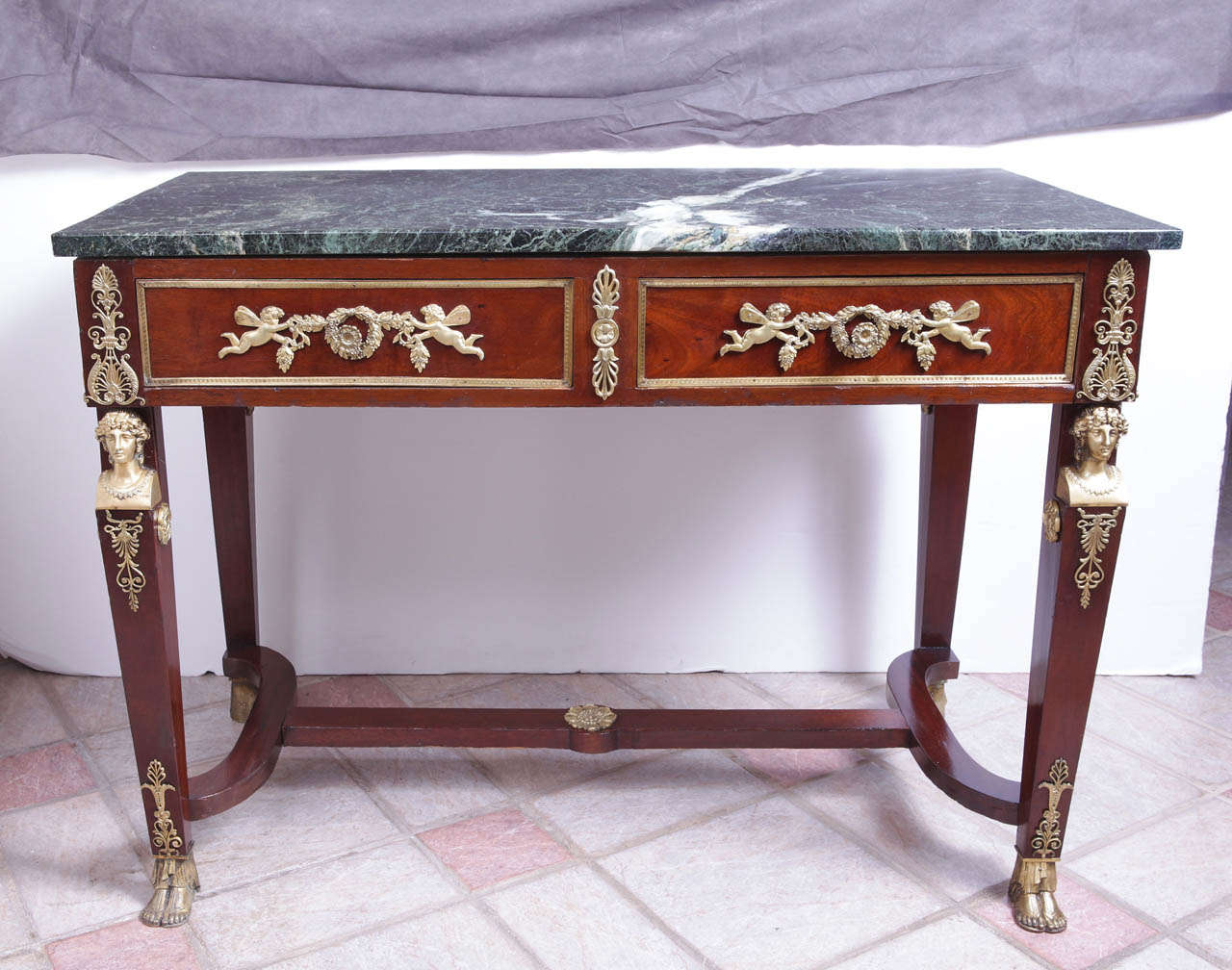 19th century Empire Napoleon III gilt bronze and marble topped console with two drawers and bronze on both sides.