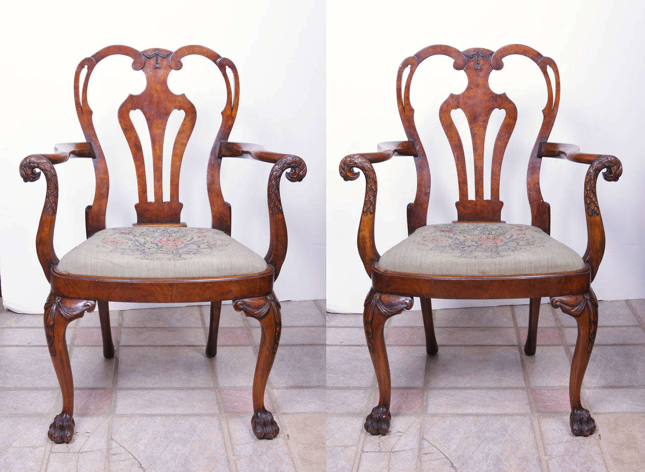 19th Century Irish Chippendale walnut open armchairs with carved eagle head arms and hairy pawed feet.