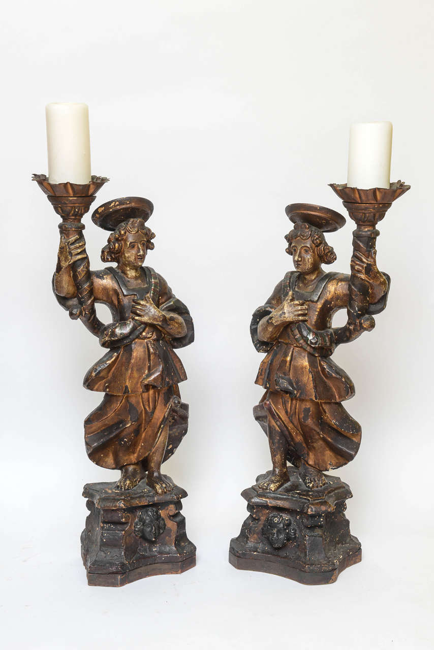 Pair of 19th century Italian Baroque figural pricket stands. The figures are terracotta with wood 