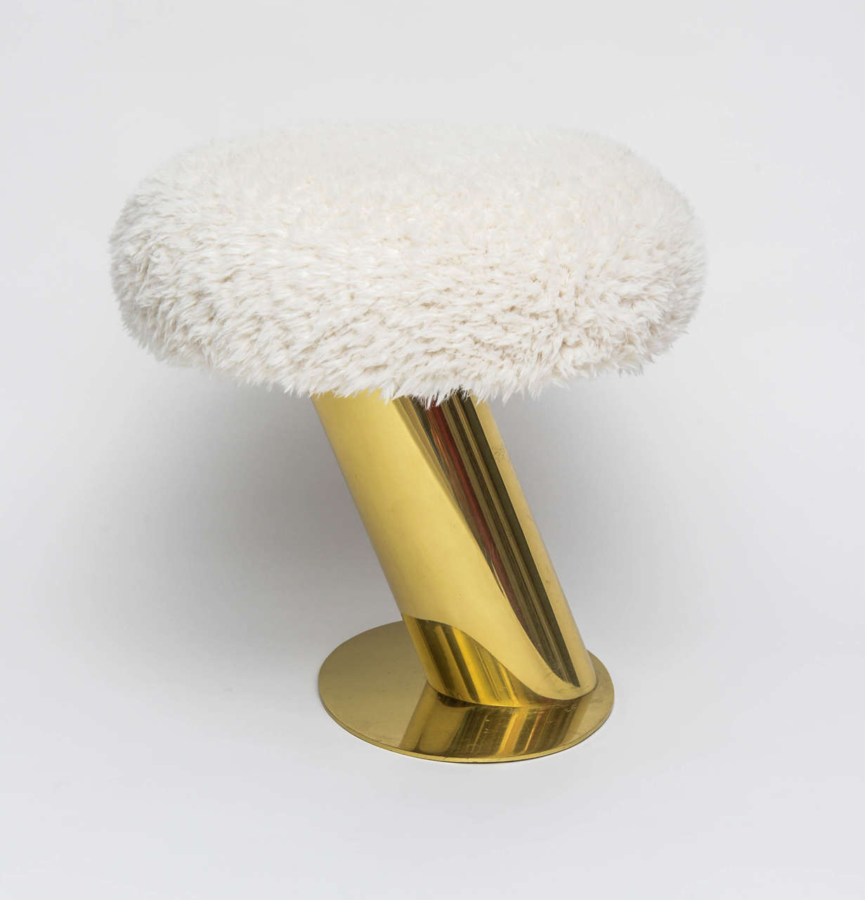 A very rare stool executed in brass and faux sheepskin upholstery.