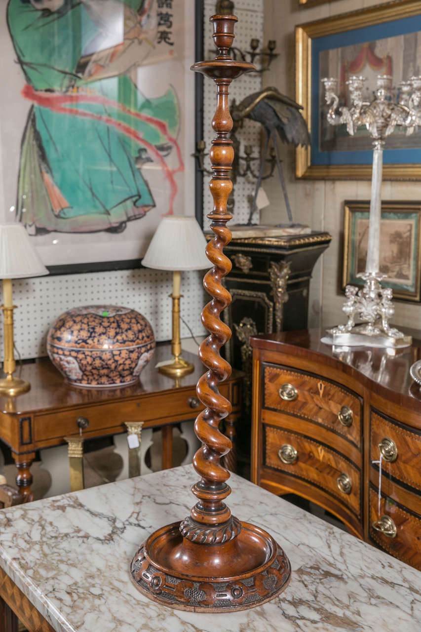 A walnut floor standing barley twist candlestick. Turned candlecup above integral turned boubeche,  above turned  section, above barley twist center.
Large round, carved, deep  bottom dish base. underside with stamp 
