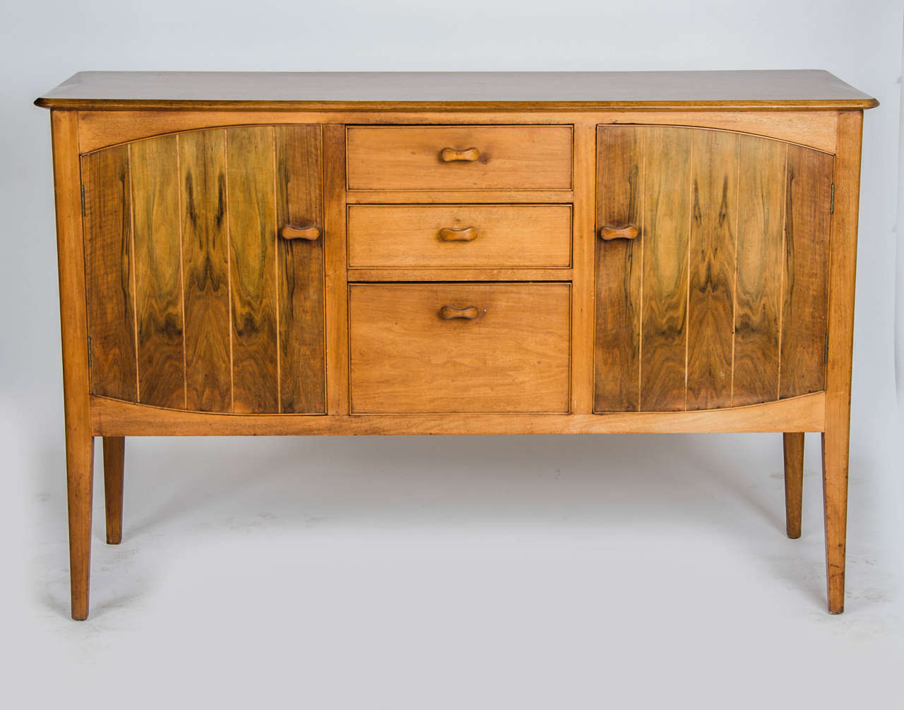 A Heals of Tottenham Court Road London teak sideboard. This piece matches the Heals table and six chairs available on our Reload storefront.