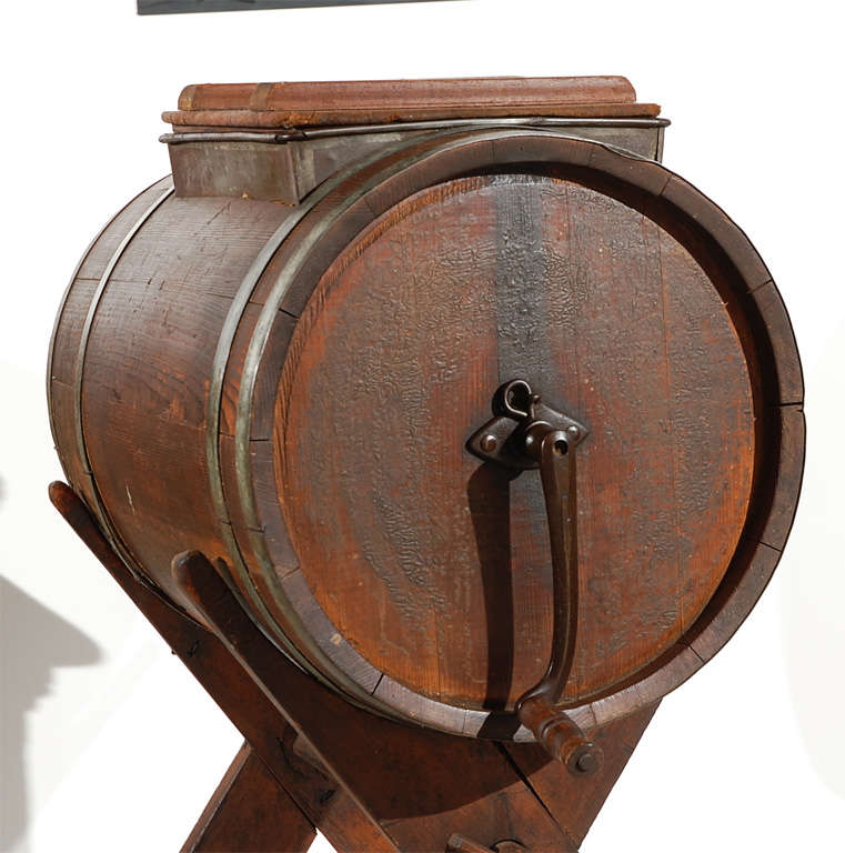 EXTRAORDINARY EARLY 19THC FOLKY BUTTER CHURN ON STAND .THE FORM AND CONSTRUCTION OF THIS WONDERFUL NEW ENGLAND CHURN HAS SUCH GREAT PRESENTS.IT IS WOOD PEG AND EARLY HAND MADE NAIL CONSTRUCTION. THE BANDS ARE HAND MADE CUT TIN AND THE TOP OPENING OF