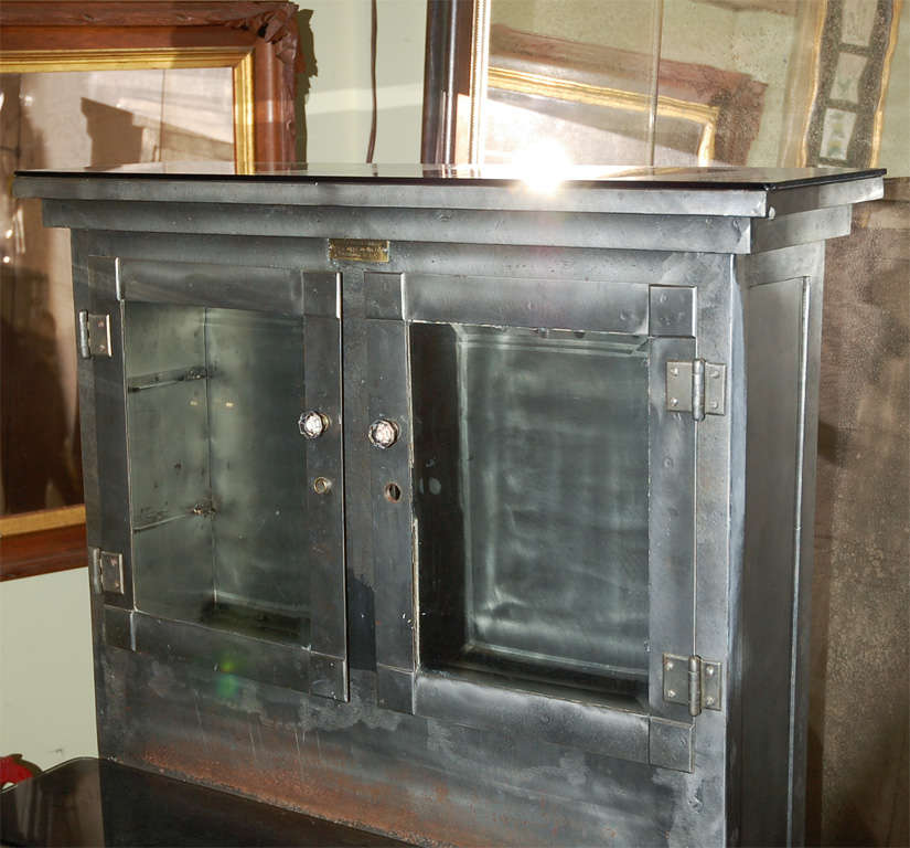 C. 1920 steel dental/medical cabinet. This piece has it all--great style, lower storage, upper storage behind glass front doors, six pie shaped drawers that pull out, and counter space. Great look in a bathroom, kitchen, dining room, or anywhere