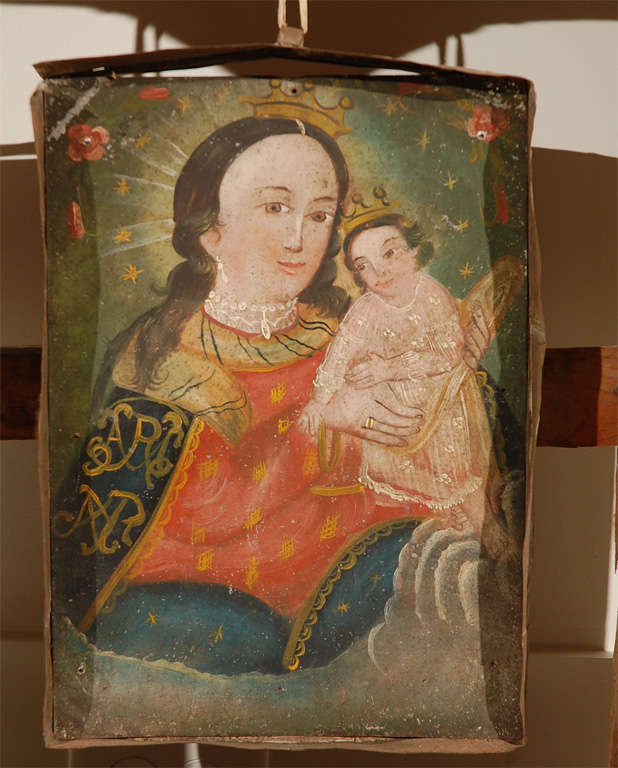 Primitive painted wooden altar frame with a suspended retablo painting (recessed in tin box frame)  of The Holy Mother and Child. The retablo painting and the frame are not a set, but have been paired together by the gallery.