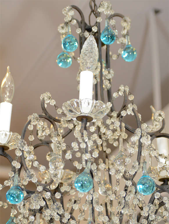 A petite French chandelier with five lights and an iron frame adorned with clear and blue crystals. Recently rewired.