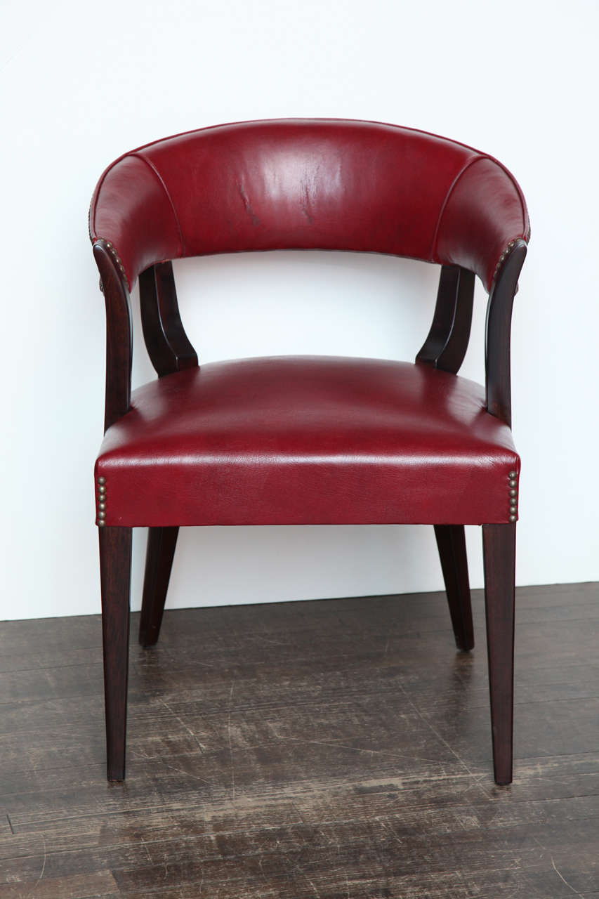 Dark wood sculptural frame with lot's of open space and tepering details.   Seat and curved back upholstered in burgundy leather with nail head finishing.   *To see our entire inventory, go to www.donzella.com