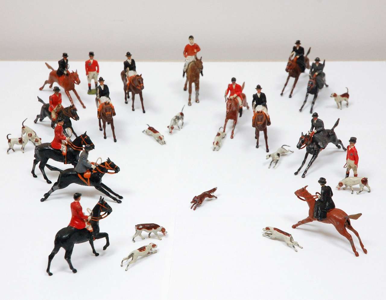 Incredible vintage set of twenty-eight British fox hunt figures, circa 1930's.  The set is comprised of sixteen hand-painted metal figures- male and female- riding horseback and standing.  They are approx. 2