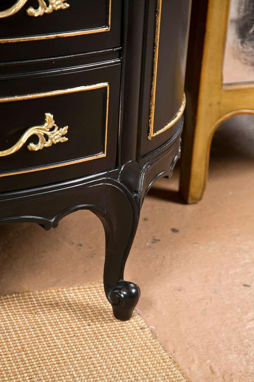 Pair of Ebonized Faux Marble Top Demilune Commodes