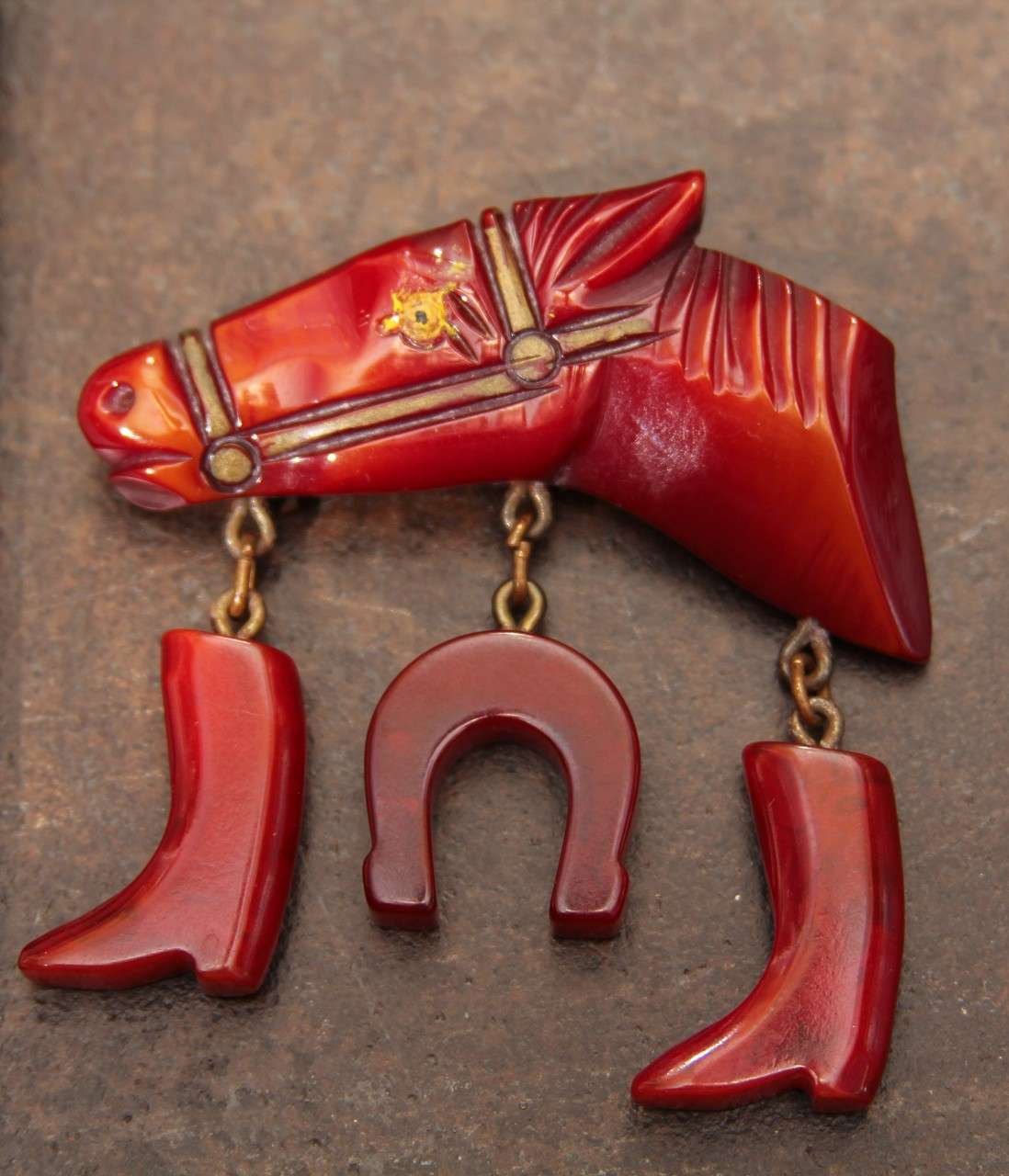 bakelite horse pin with pair of boots and horseshoe for luck