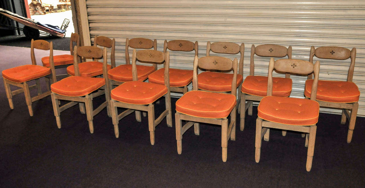 Set of twelve 1950's solid blond oak chairs by Guillerme et Chambron. Orange wool fabric. Very good condition. Normal wear consistent with age and use.