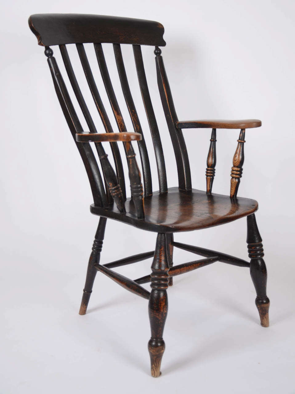 A 19th century beech and elm Thames Valley lathe back Windsor armchair, retaining much of the original painted surface.  The years of enjoyment (and it is incredibly comfortable!) and waxing mean that the chair has a lovely patina and colour with