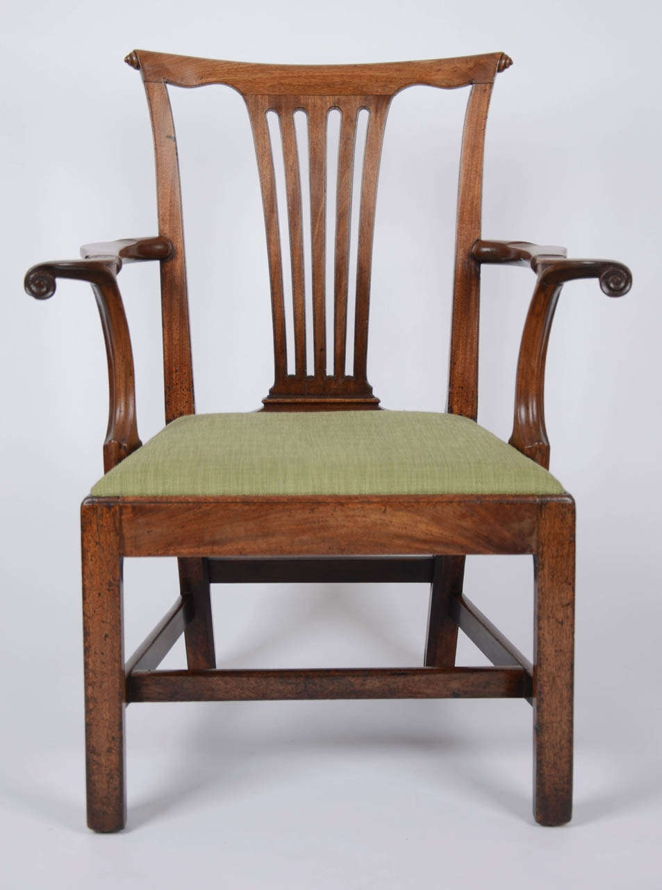 A George II mahogany open armchair with unusual outswept scroll and cuff arms, scribed detail and scroll and shell top rail.  It is a wonderfully drawn, well proportioned and comfortable chair of great character.

Mahogany with reupholstered drop