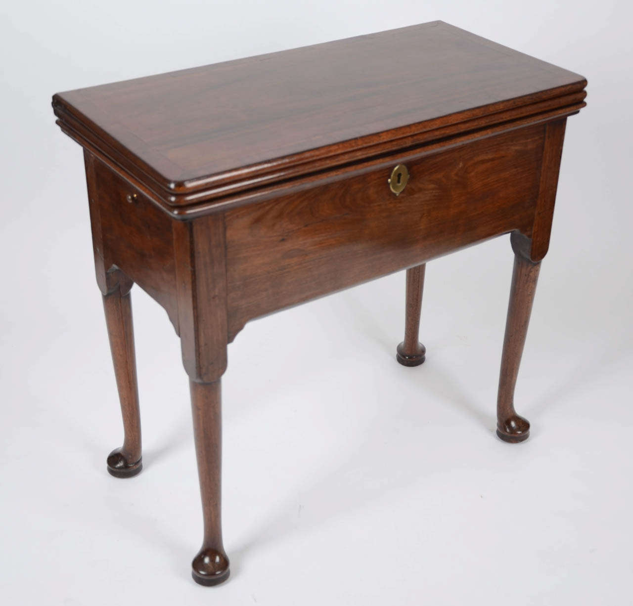 This very ingenious pier/tea/games bureau-table reflects the George II French style and fascination for metamorphic furniture as favoured in the 1730s for fashionable London parlours and reception rooms.   The crossbanded and featherbanded top